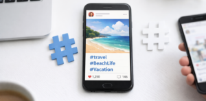 Texto alternativo: Smartphone mostrando una publicación en redes sociales con una imagen de playa y hashtags de viaje, junto a símbolos de hashtag sobre un escritorio, representando el uso de hashtags para aumentar el alcance en redes sociales.